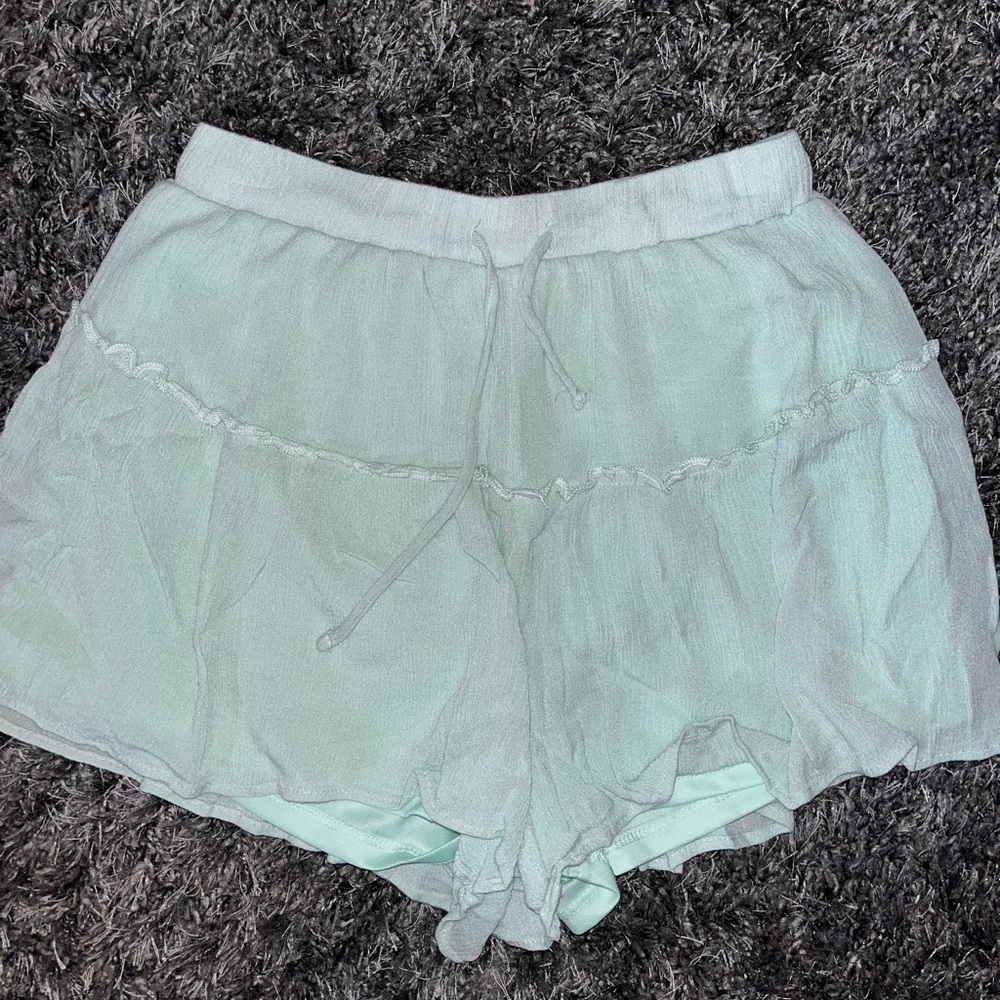 green ruffle shorts